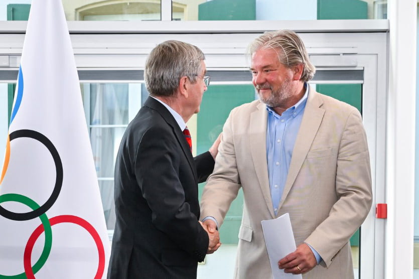 International Olympic Committee President Thomas Bach congratulates Matt Robinson